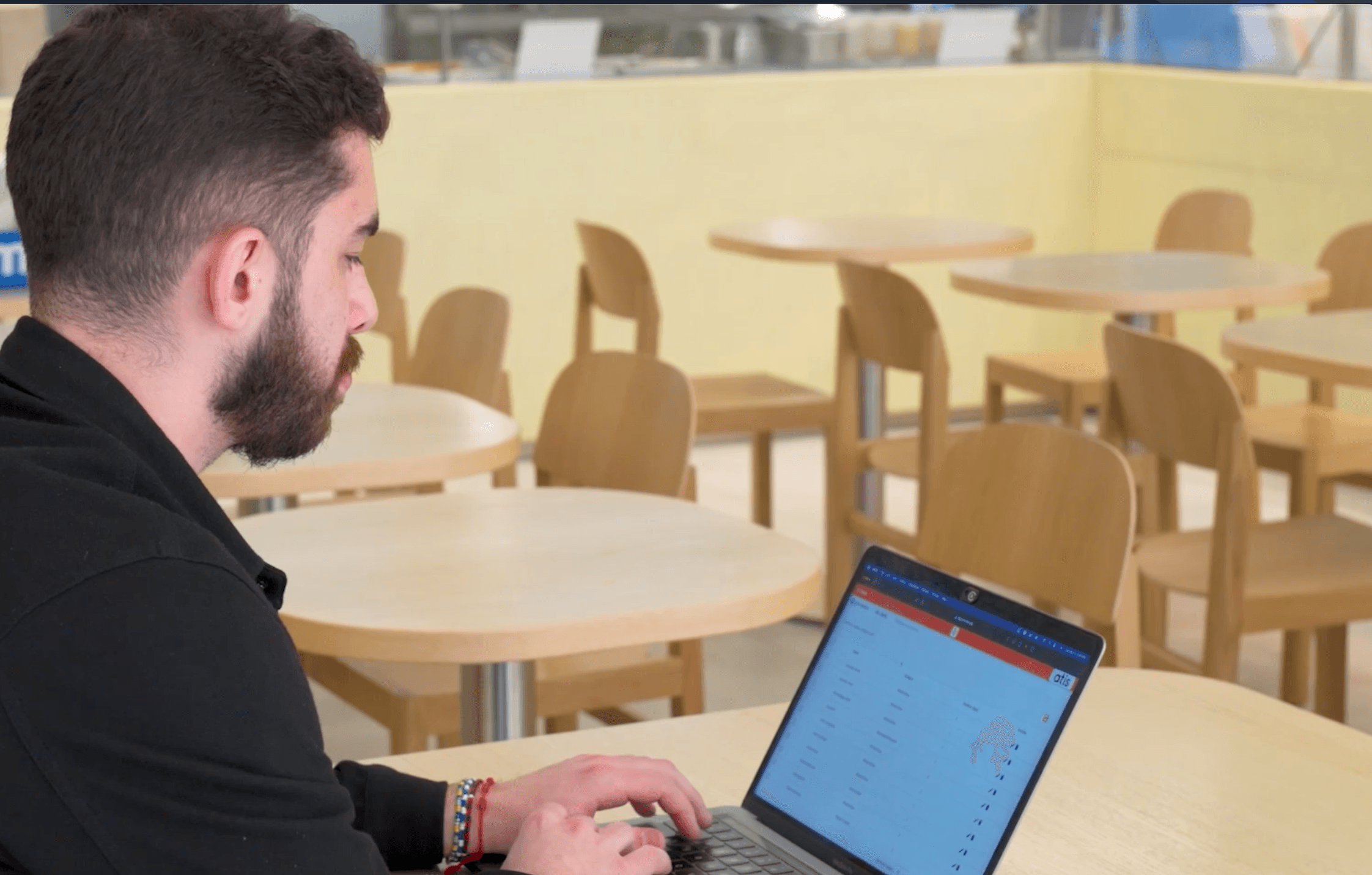 Manager configuring menu and allergen data on laptop