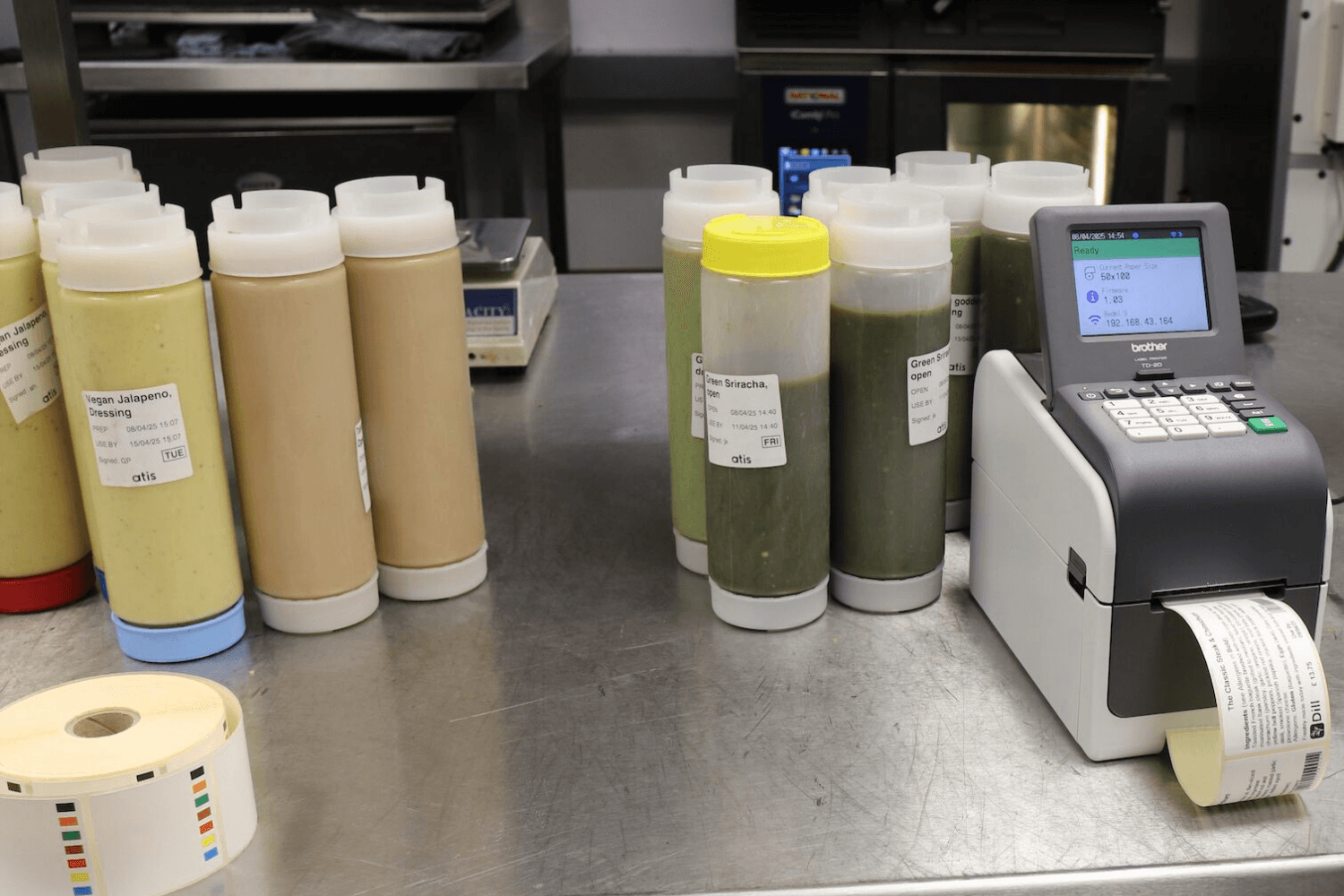 Kitchen printer printing labels next to sauce bottles in a QSR kitchen